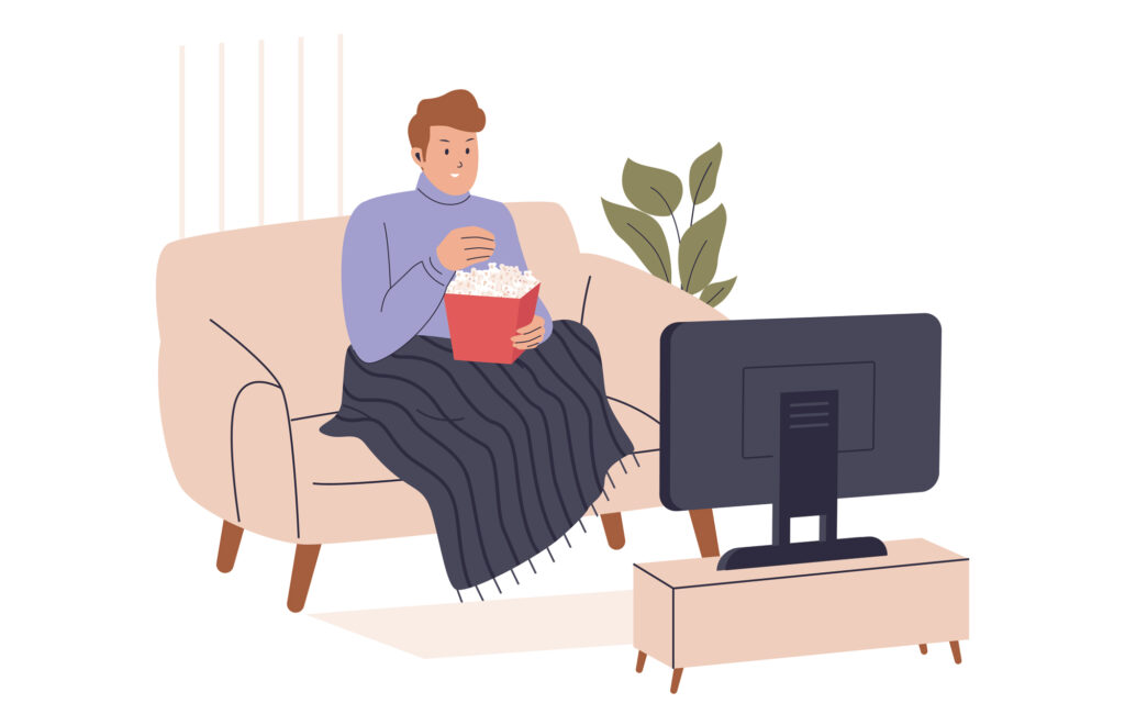 Person relaxing in a warm Kiwi home, watching TV in comfort thanks to a winter loan from Loansmart.